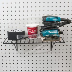 Steel pegboard shelf holding tools and accessories