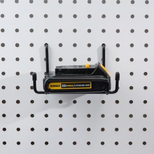 DeWalt battery packs stored on pegboard wall hangers