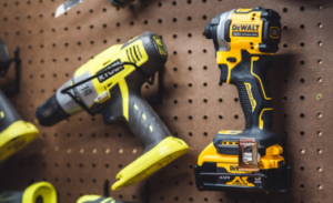 Cordless drill and impact driver hanging on pegboard with Tool Hangerz drill hangers